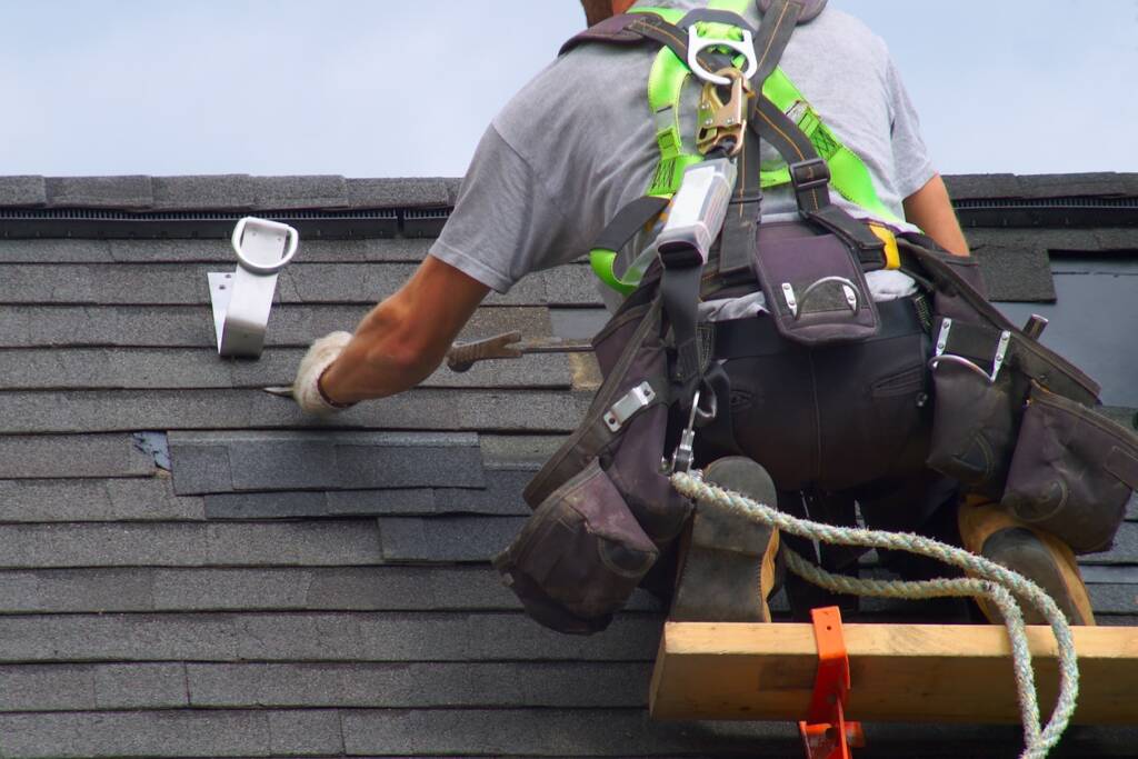 Roofing professionals installing MasterShield gutter protection